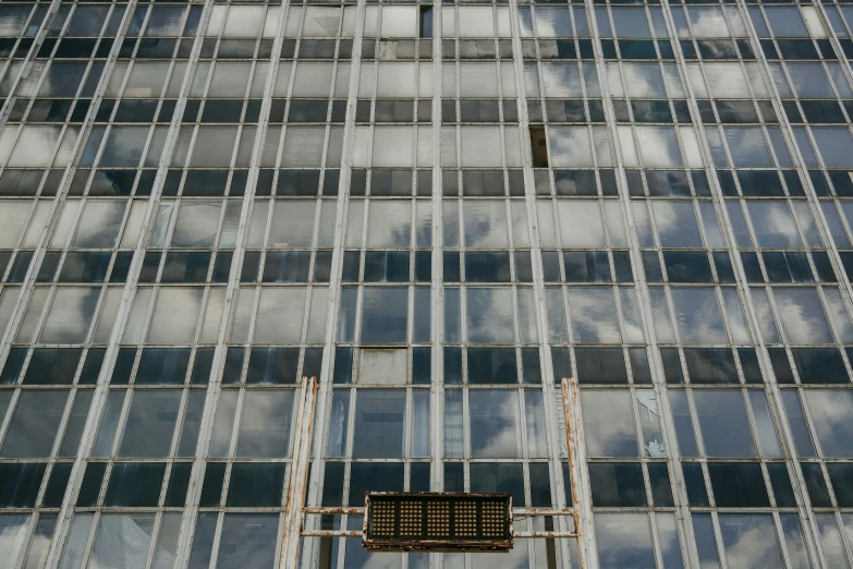 a tall building with several glass windows and an upward angle