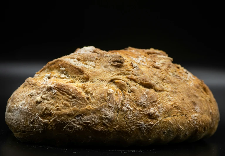 a close up of a big piece of bread on a table