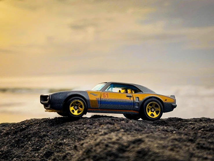 a  wheels movie car sits on a beach
