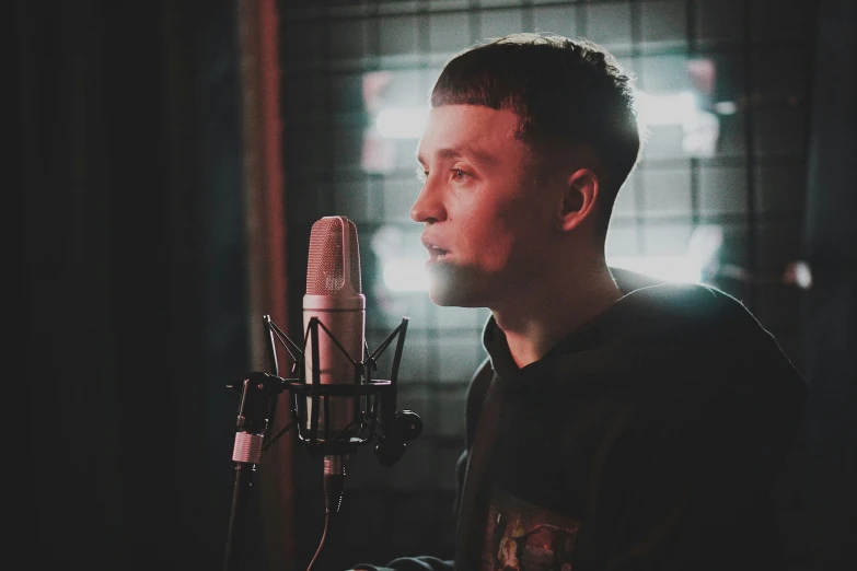 a man in a recording studio with a microphone