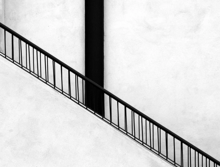 black and white po of a person walking down a railing