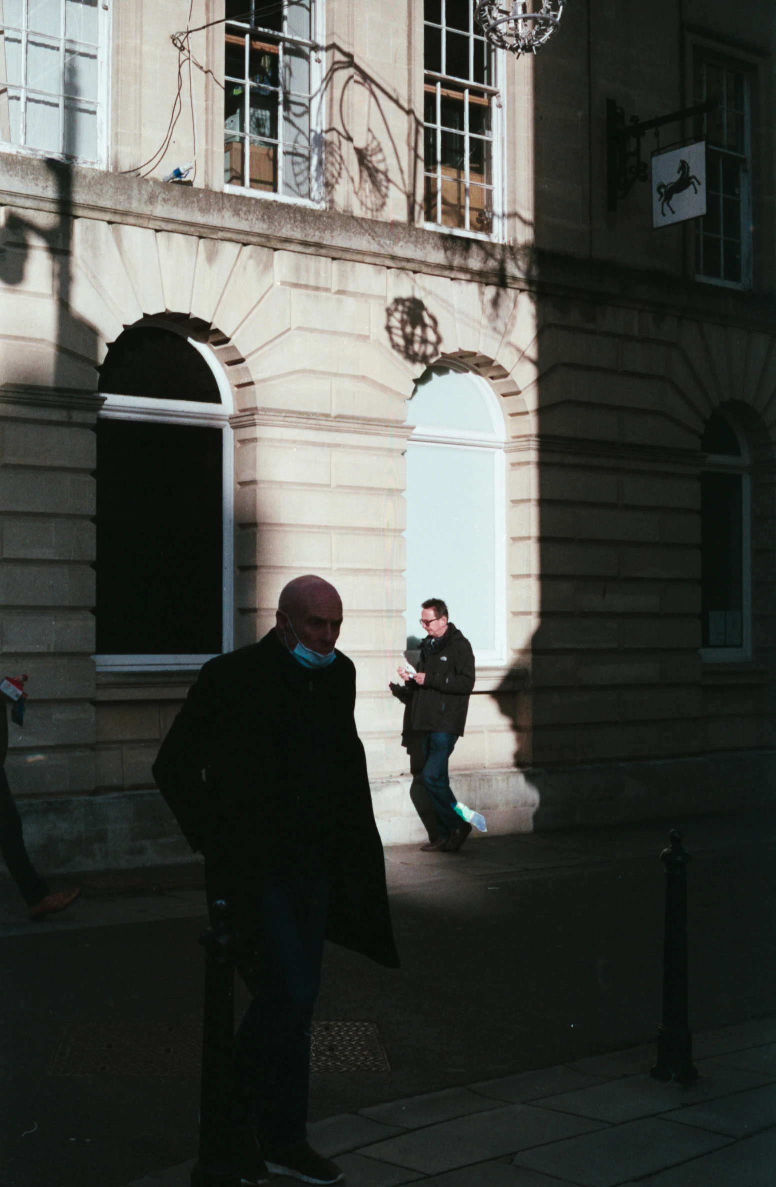 people walking by an old building and talking