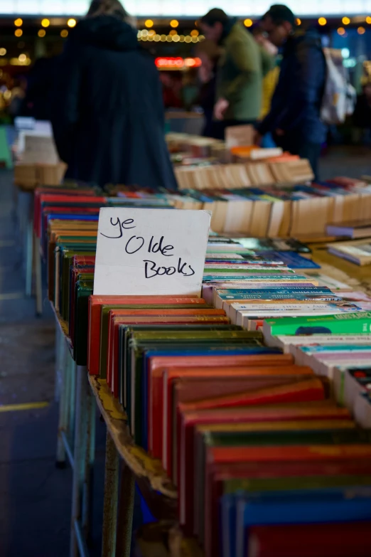 books and people walking in an open market area