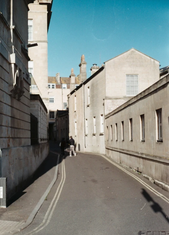 a street has two people walking on the side