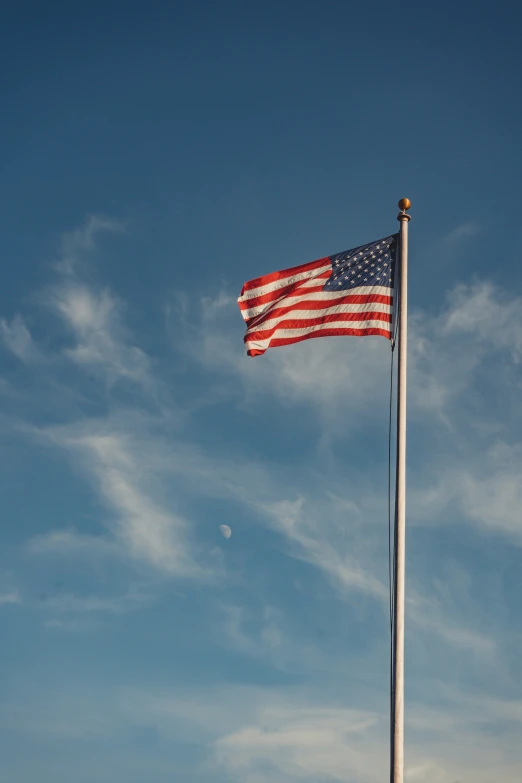 an american flag is waving in the wind