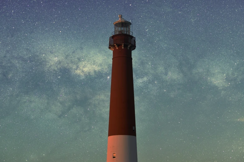 a tall light house sitting under the stars