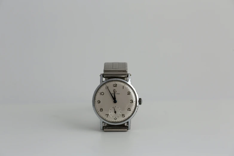 an analog watch is pictured on a white background