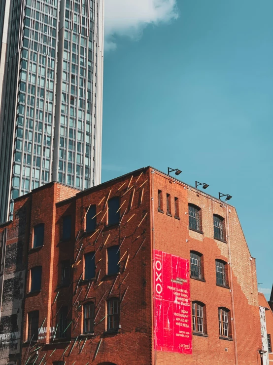 a tall building in front of two large buildings