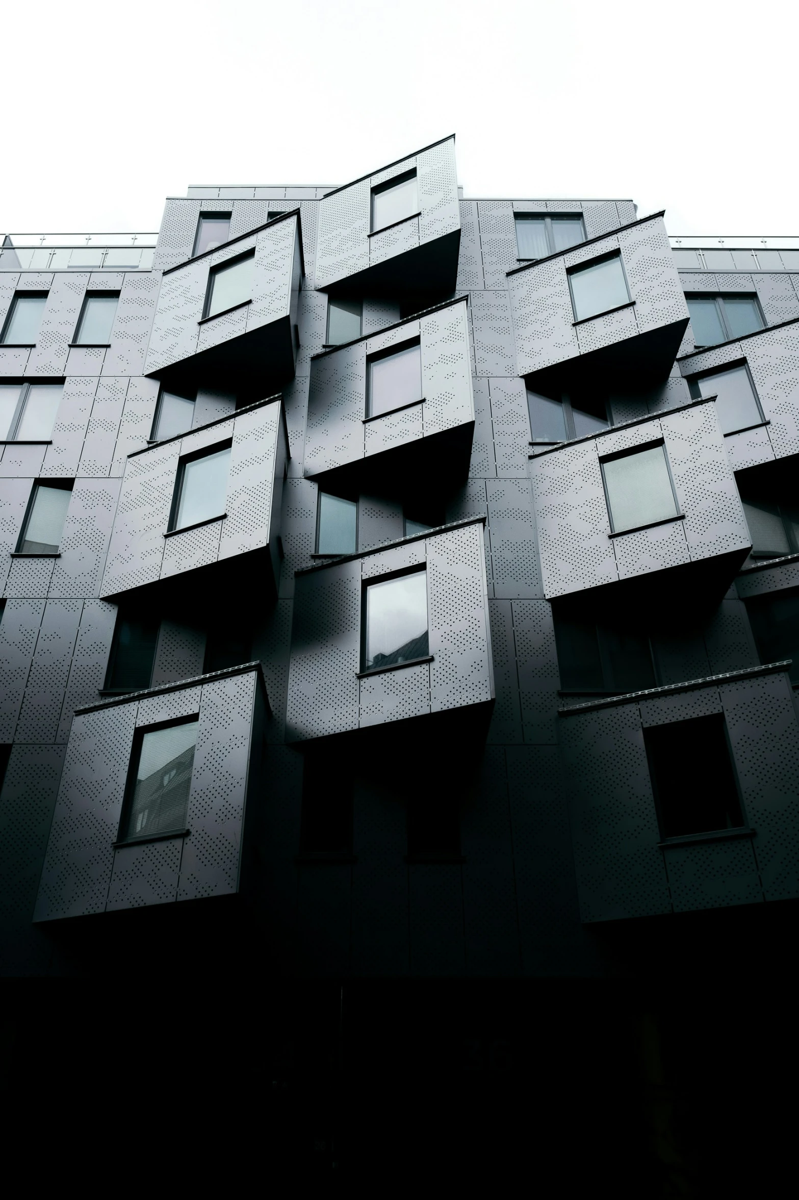 a building with lots of windows and open doors