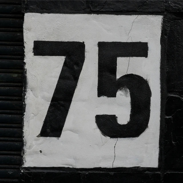 a close up of a street sign with the number seventy seven