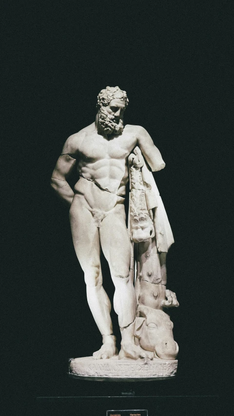 the marble statue shows a bearded man and a dog