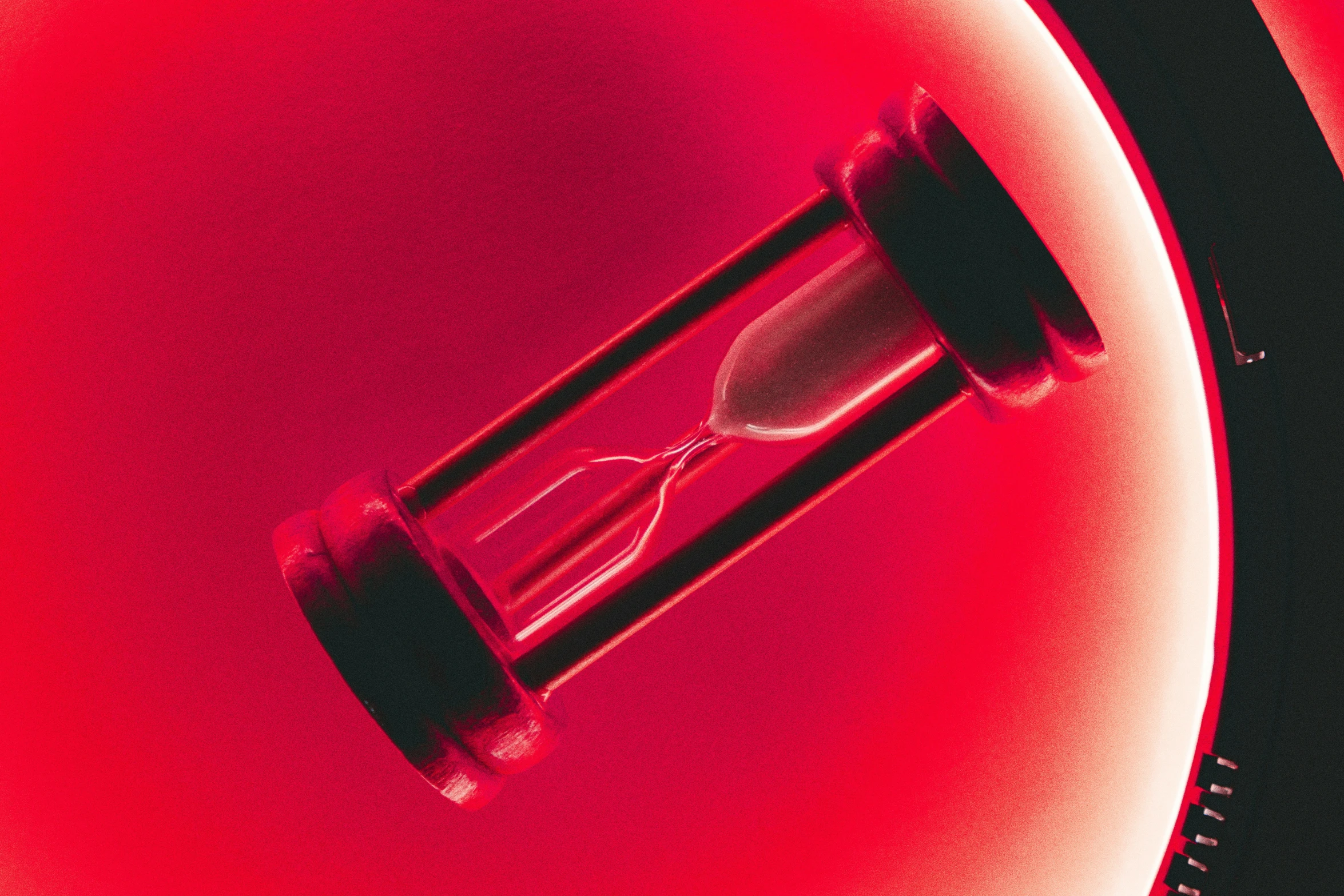 a red light inside an hourglass on top of a table