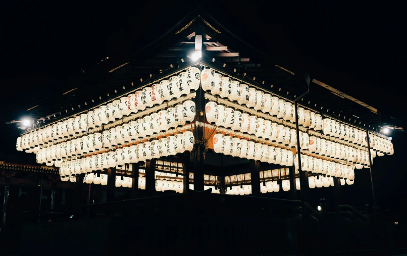 a square structure with many lights inside at night