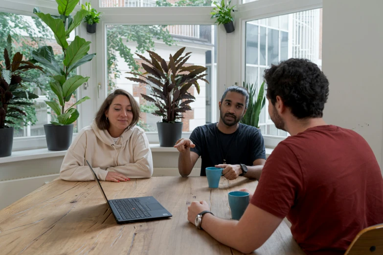 a group of friends having conversation at the table