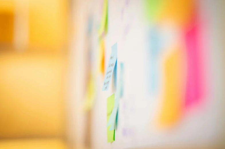 some colorful stickers are attached to a board