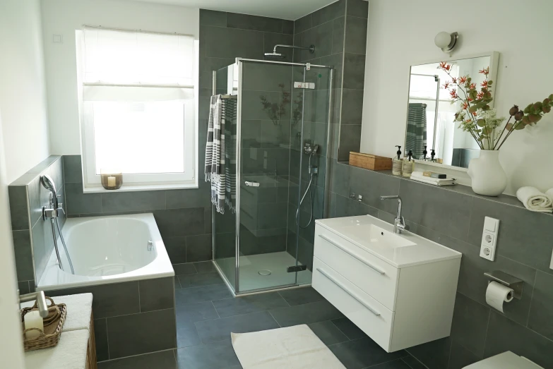 a bathroom with toilet, tub, sink, and shower