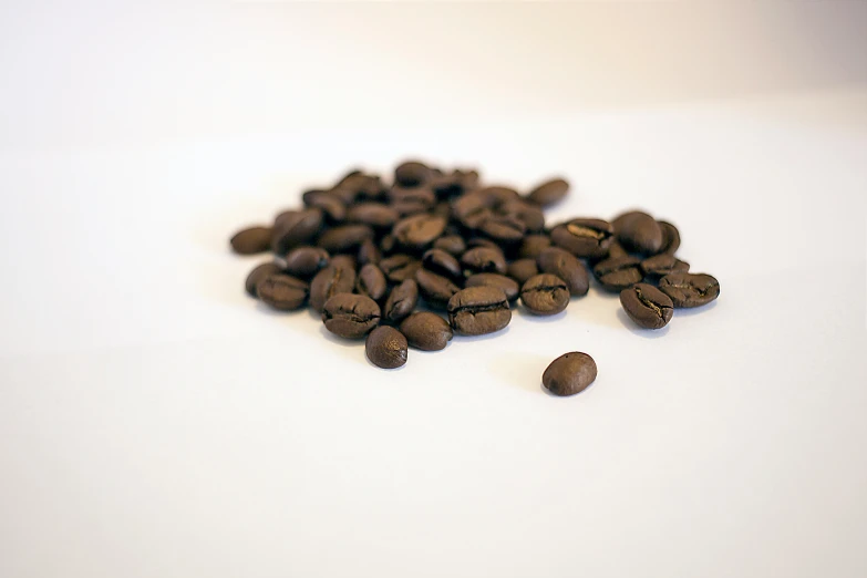 a pile of roasted coffee beans on a table