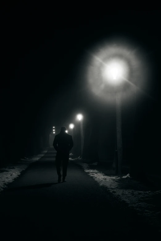 a dark street lit up by the street light