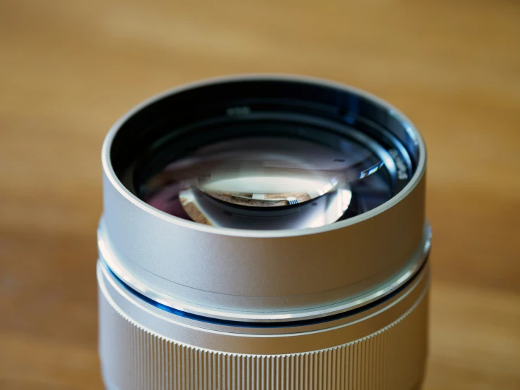 a silver camera lens on top of a table