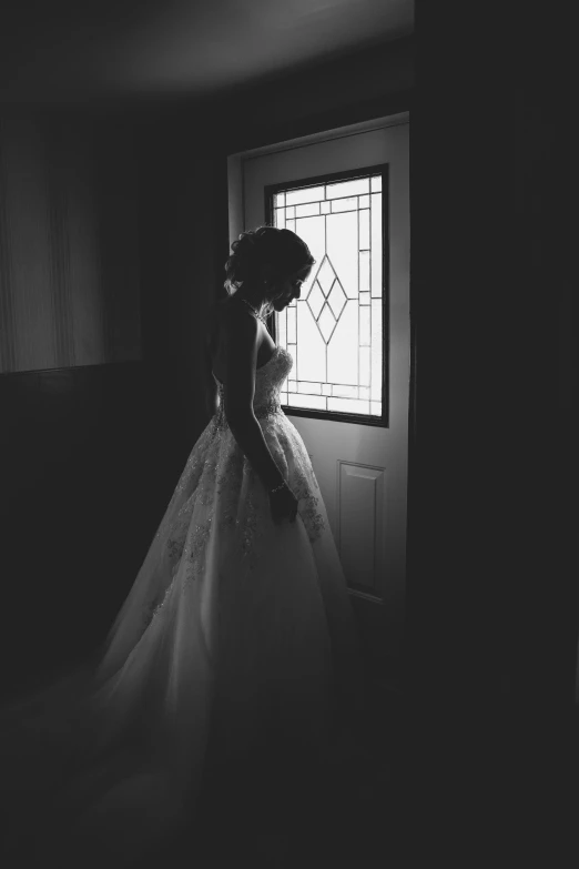 a person standing near a door and window