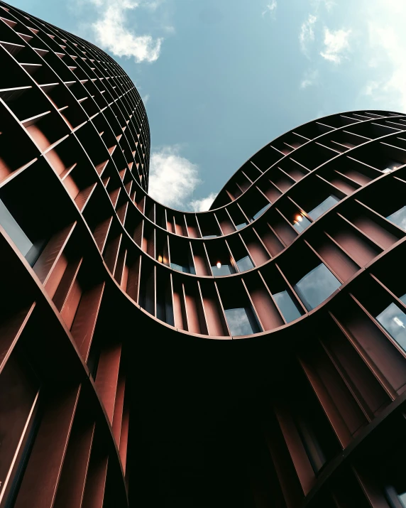 the side of an unusual building, as seen from below