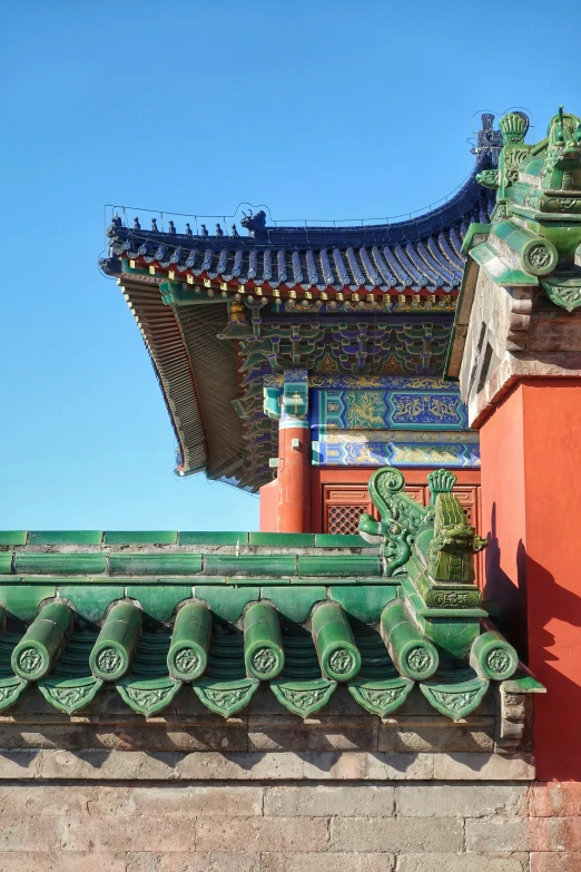 a wall and roof in front of an oriental structure