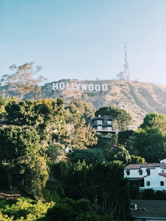 a large hollywood sign is seen on top of a hill