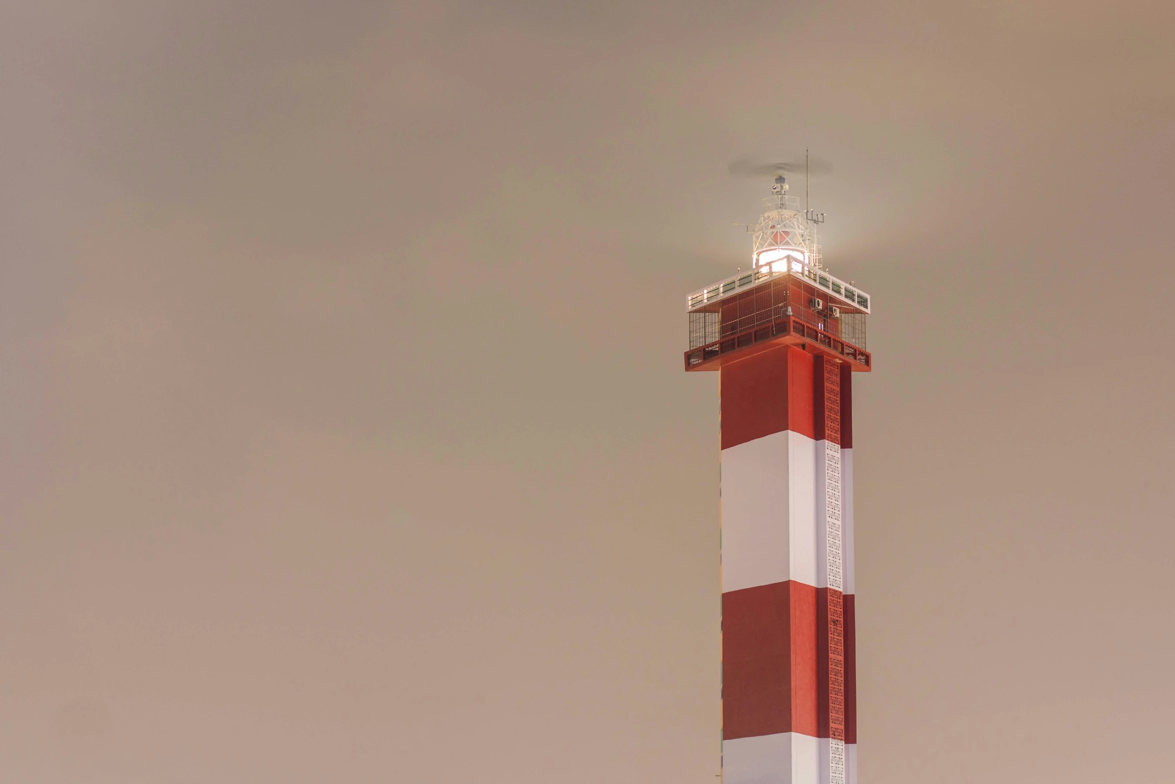 a small light house standing high on the sky