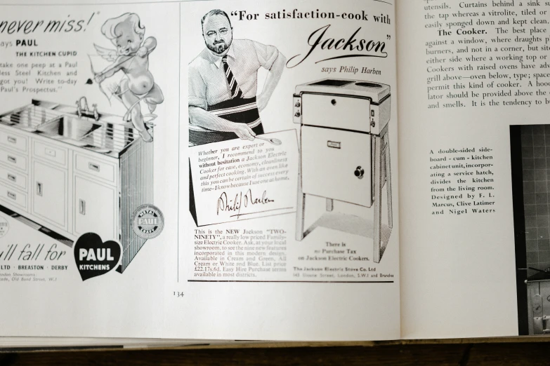 an open book on a kitchen design shows instructions for a stove