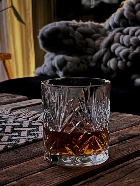 a glass is sitting on a wooden table