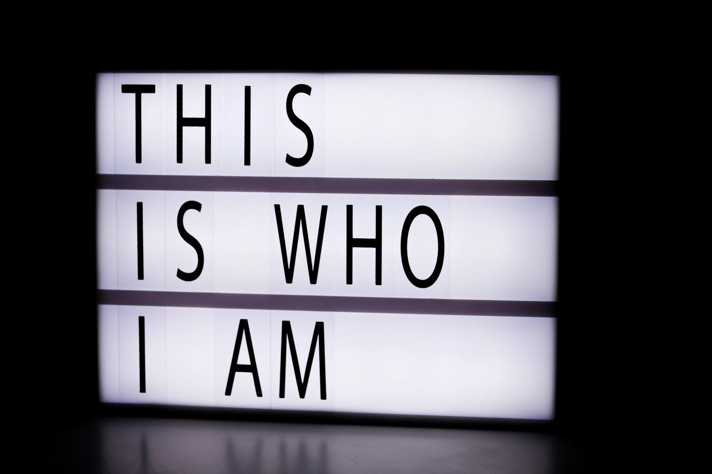 an illuminated light box with words on it