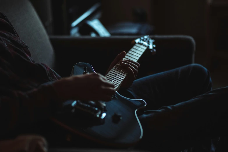 an acoustic guitar being played in a dark room