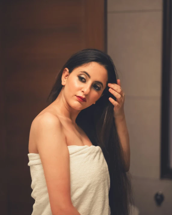 a woman with long hair poses in the bathroom