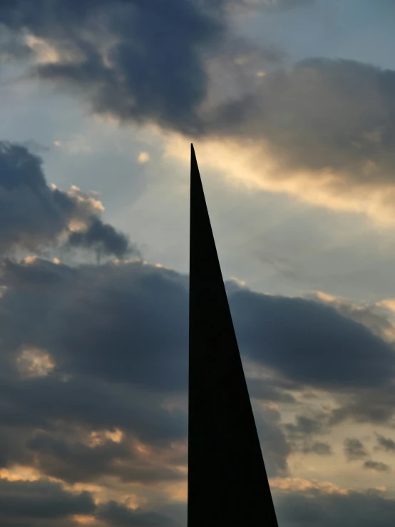 a tall monument sitting under a cloudy sky