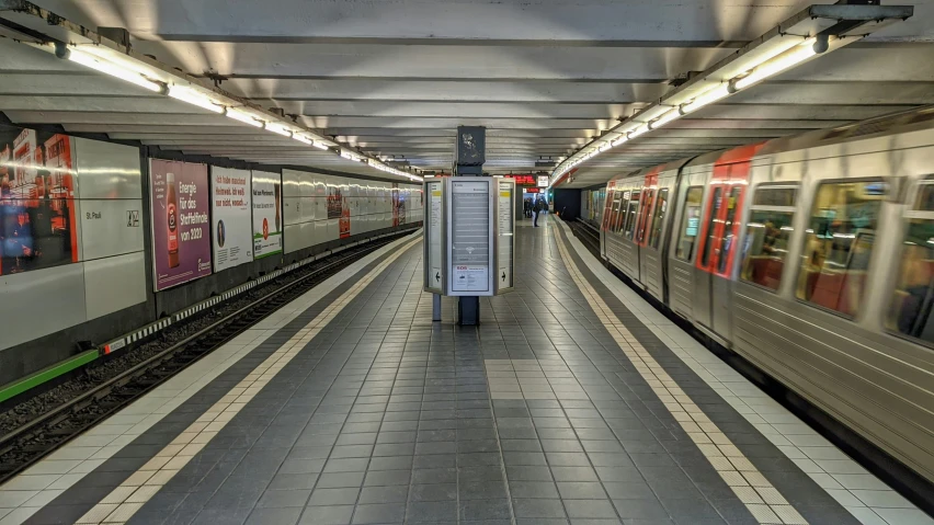 a passenger train in a subway station with several trains