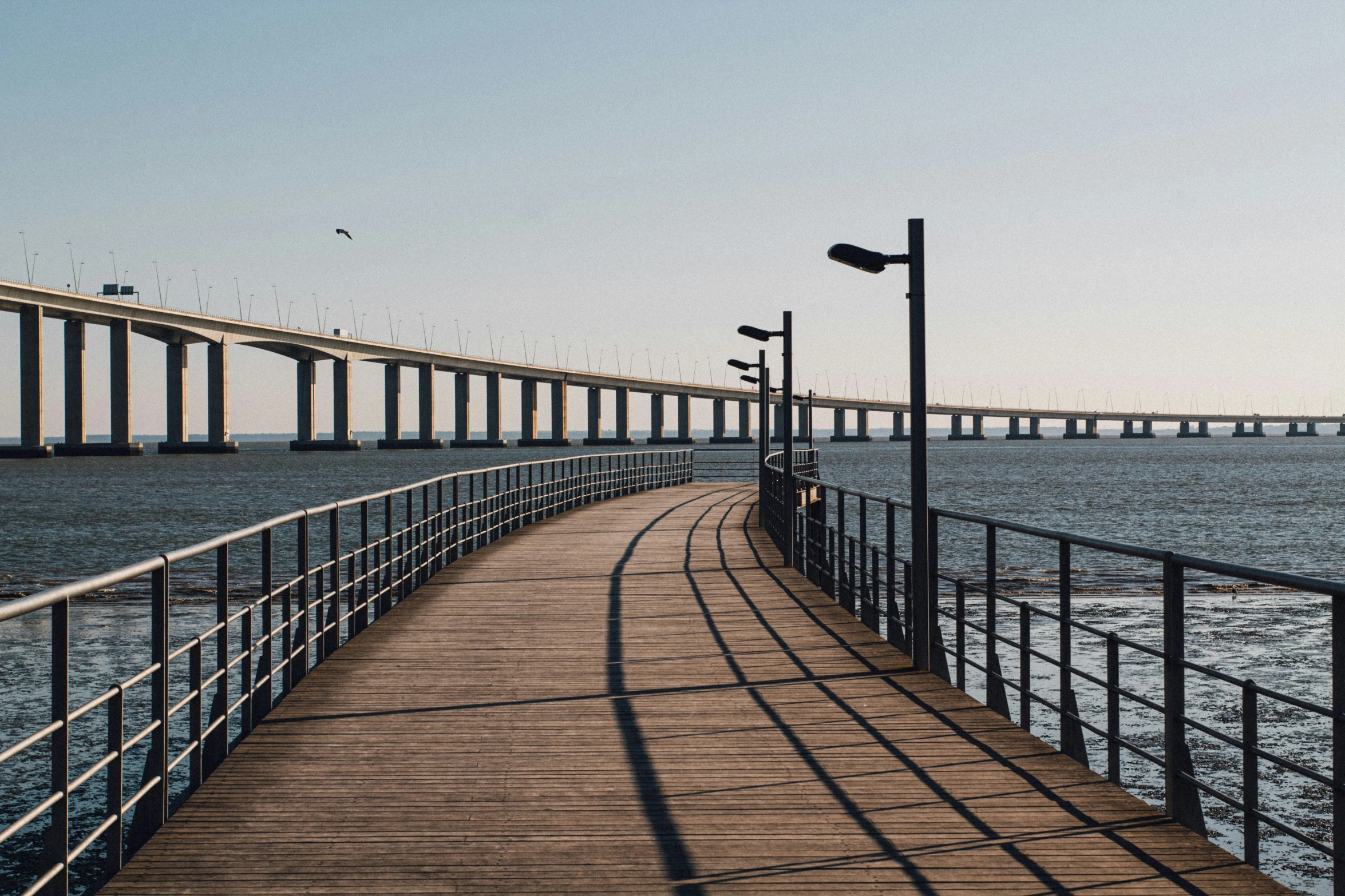 a wooden bridge that extends to the water