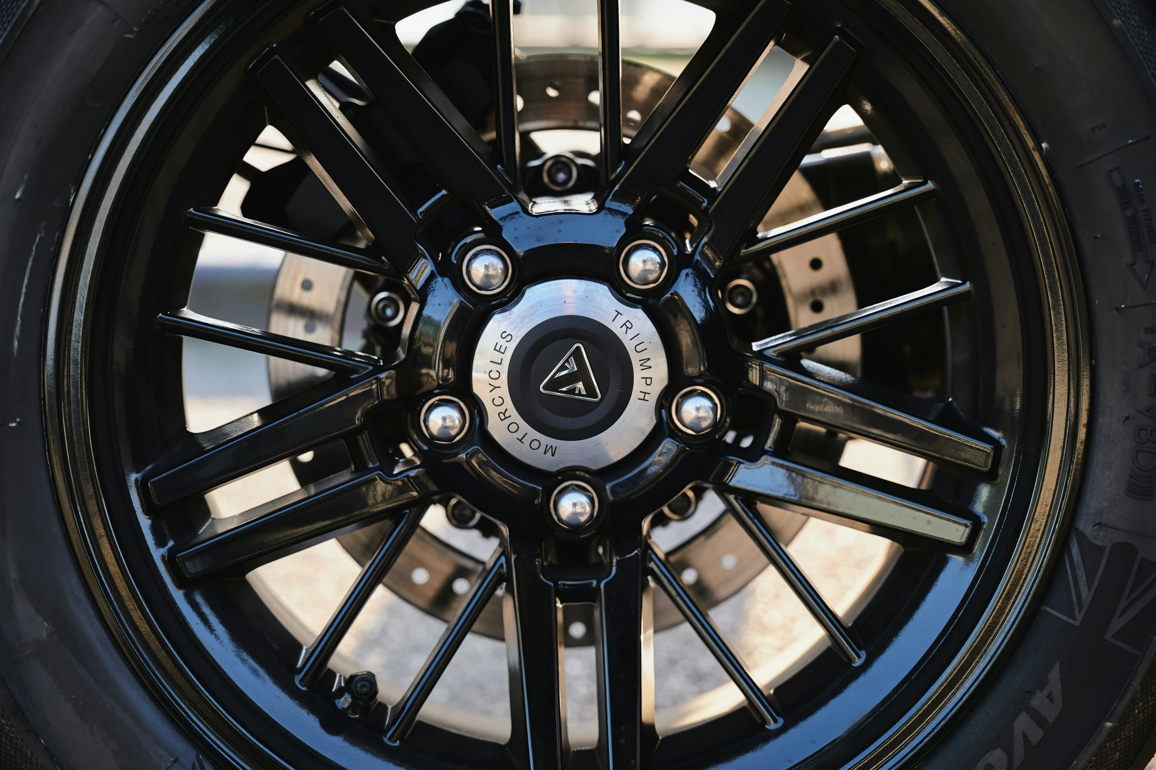 a black wheel with a white star on the tire