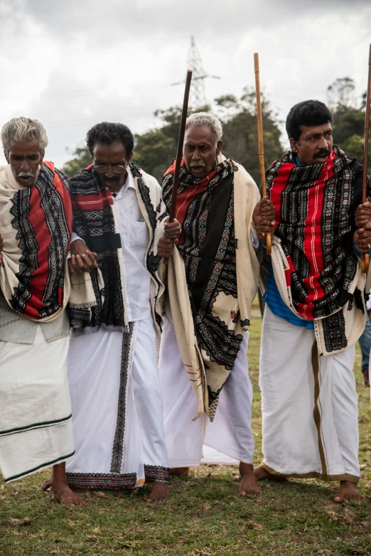 a group of men dressed in ethnic garb