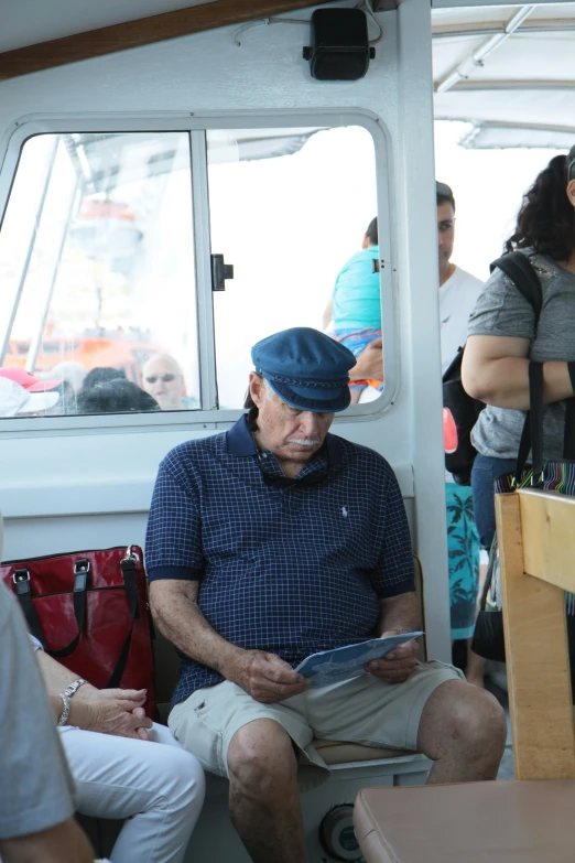 a man in a cap sitting on a boat