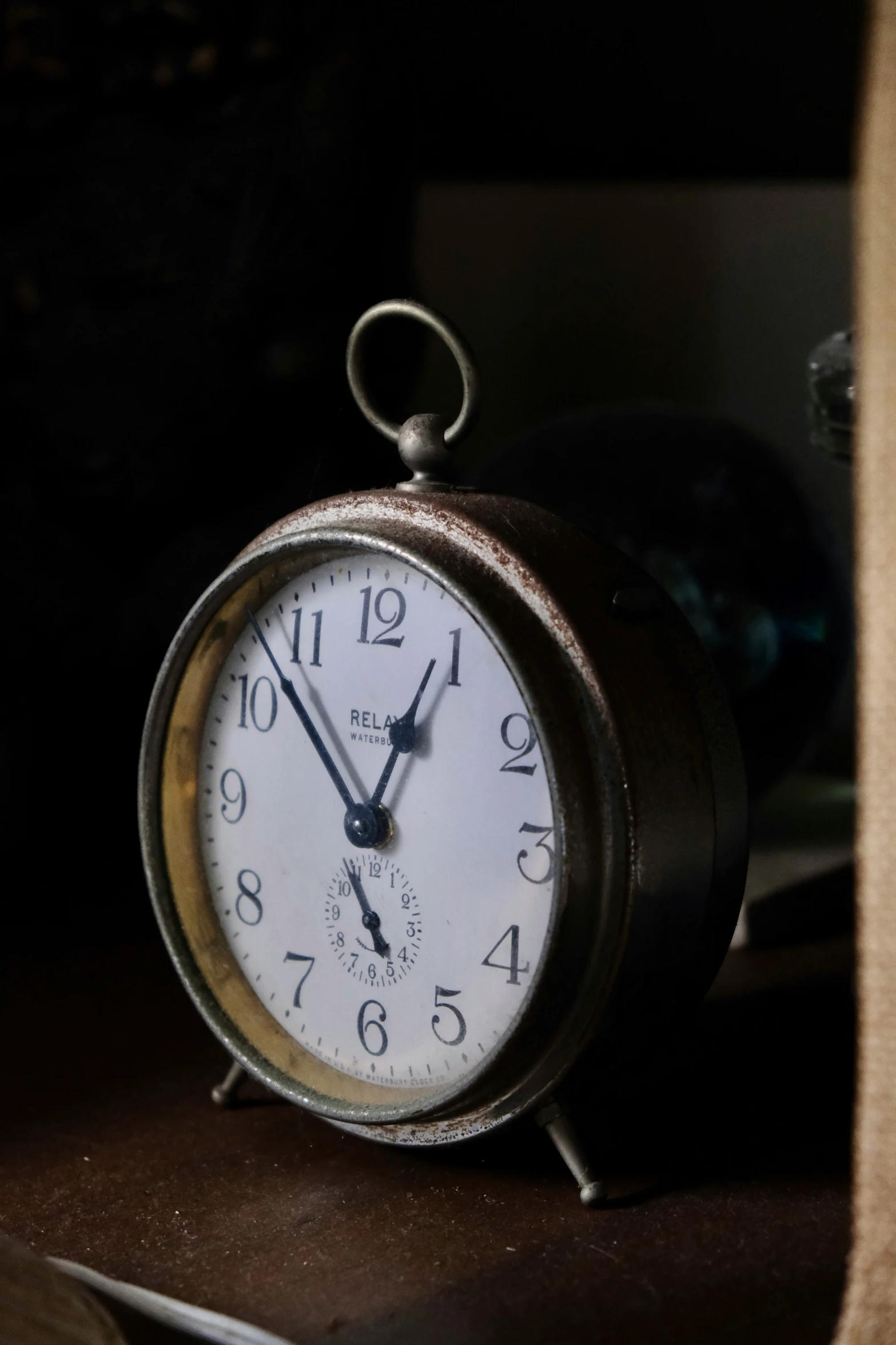 a small clock on a counter is showing the time