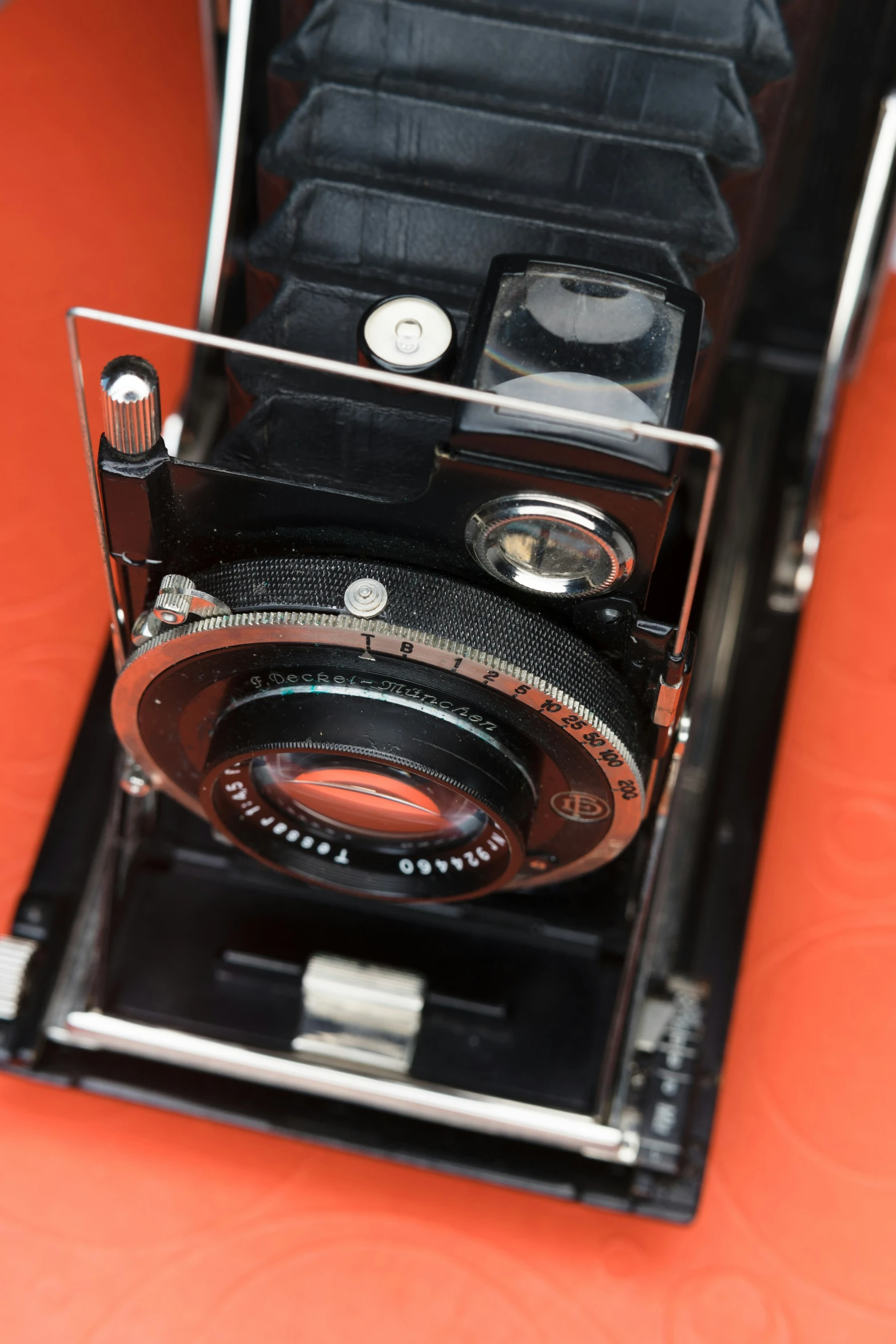 an old analog camera with other tools attached to it