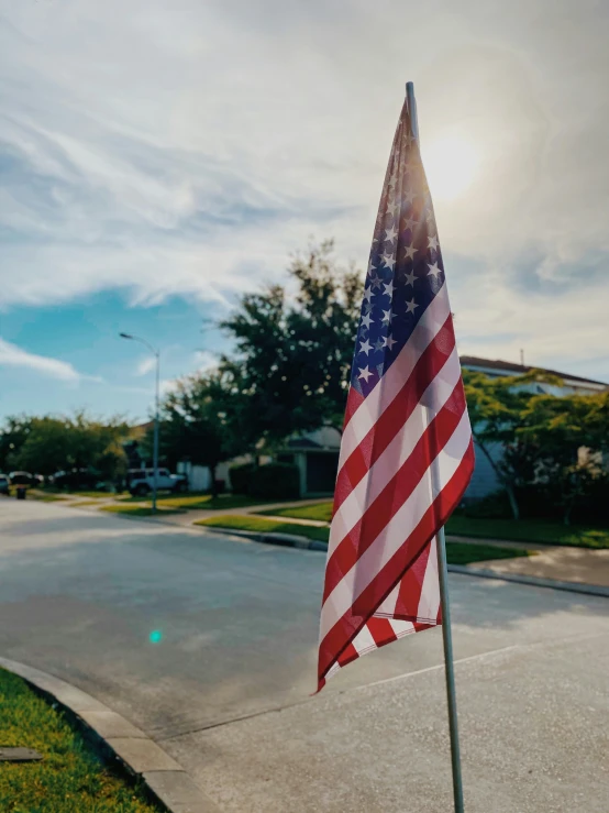 the american flag is in a grassy corner