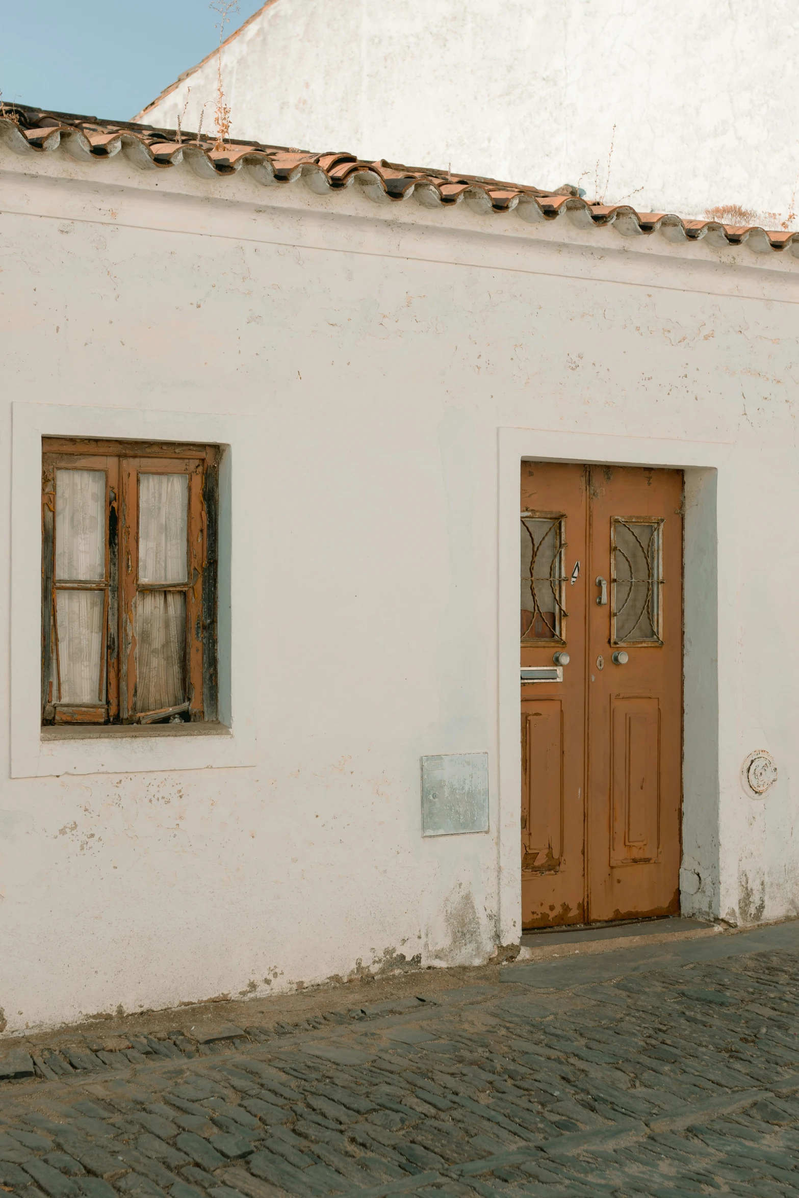 the doorway to a house with two wooden doors