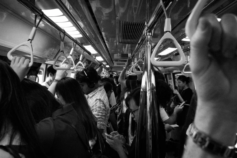 people are riding the subway train all looking in the same direction