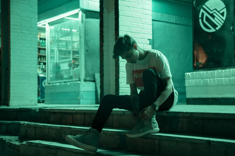 a man sitting on steps with his feet in the air