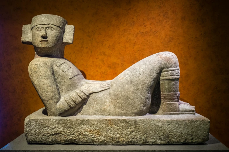 statue of woman lying down on stone slab