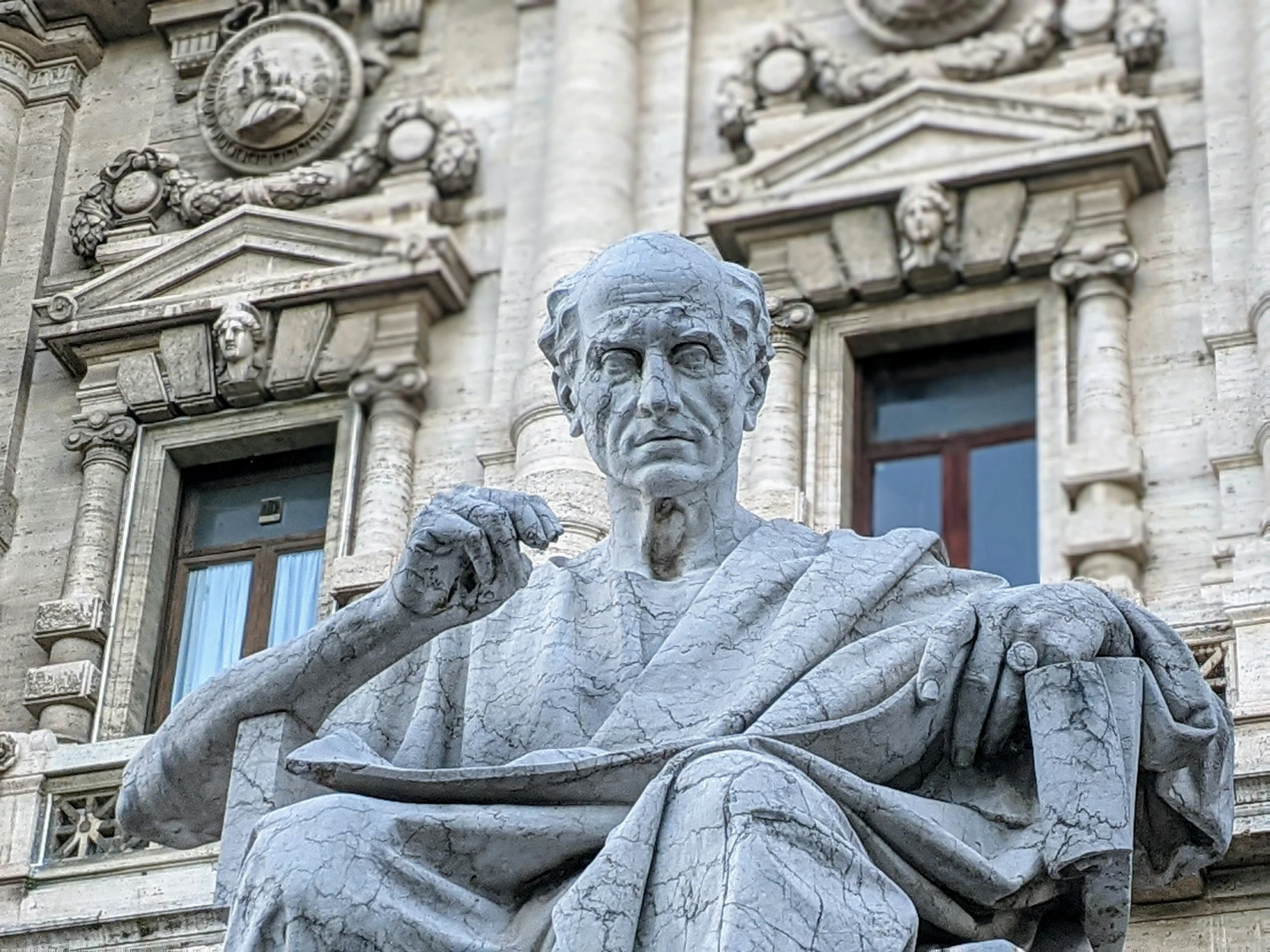 a sculpture is shown in front of an old building