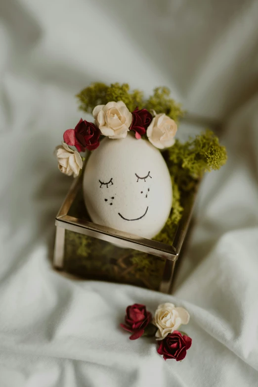 a small white egg with a smiley face painted on it