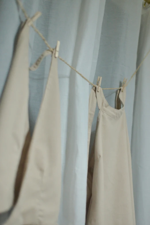 towels hanging from a clothesline on a blue wall
