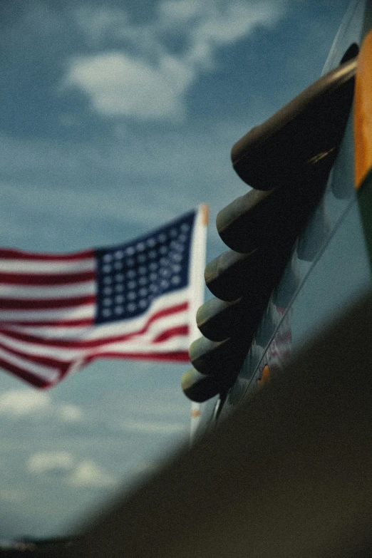 an american flag flying by and airplane